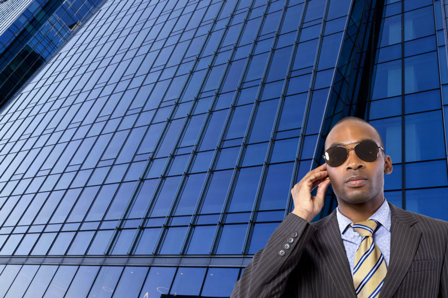 Professional security man in front of business building